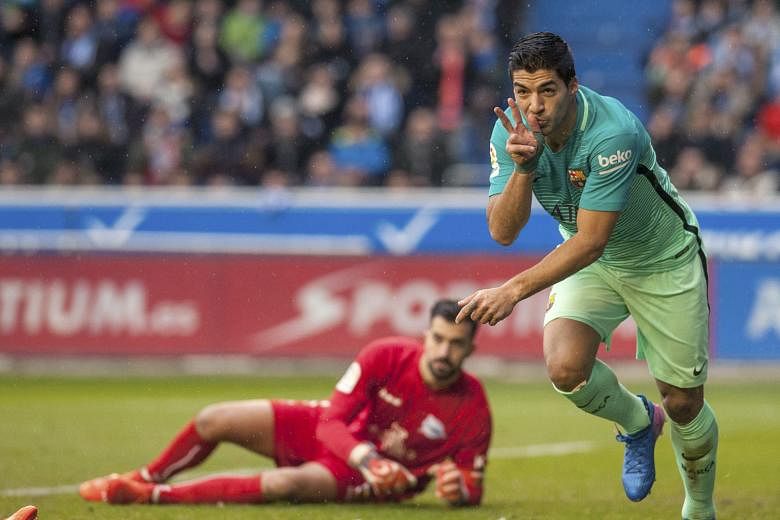 Barcelona striker Luis Suarez wheeling away in delight after scoring past Alaves goalkeeper Fernando Pacheco. Barca were irresistible as they thrashed Alaves 6-0 and will be looking for a repeat showing when the sides meet again in the Copa del Rey f