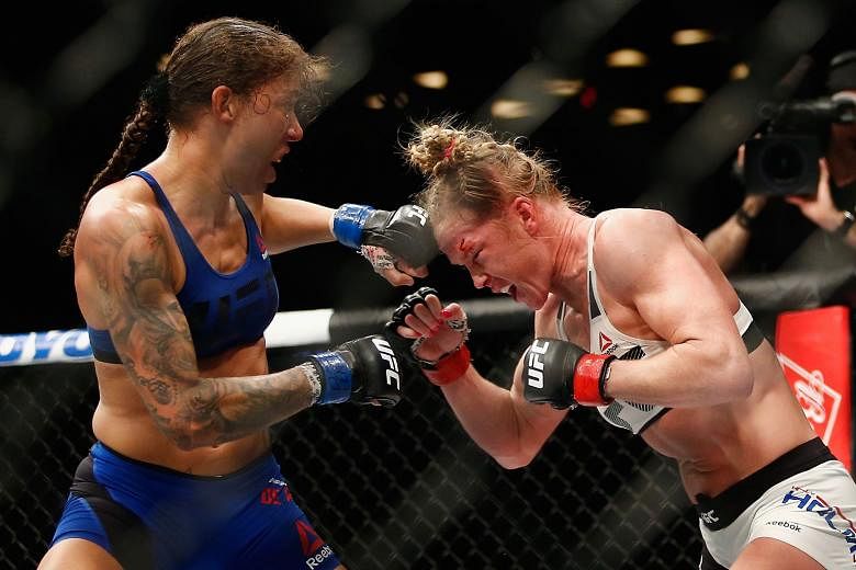 Germaine de Randamie (left) throwing punches against Holly Holm, whom she defeated to become the first UFC women's featherweight champion.
