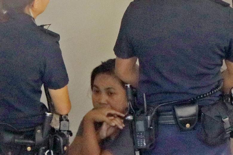 The maid, seen here with police on Monday, will be charged in court today with murder.