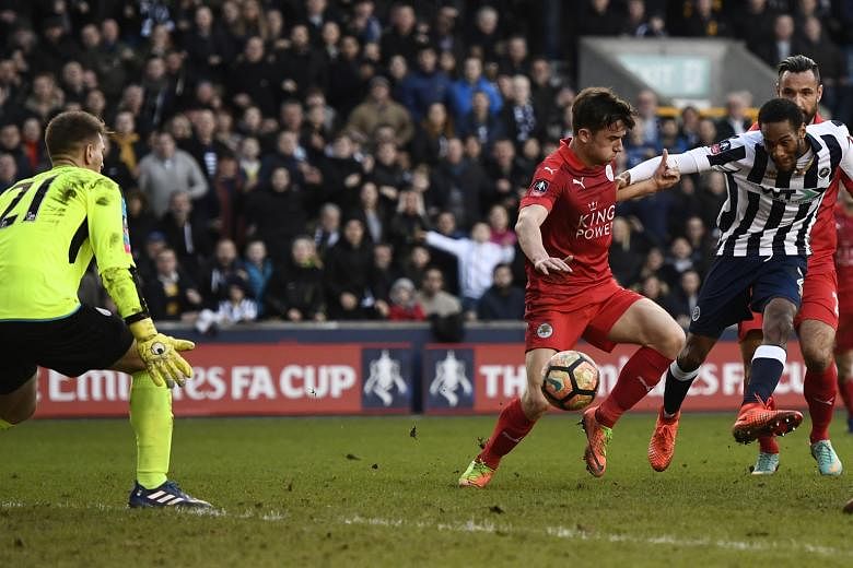 Millwall's Shaun Cummings slots home the only goal of the match in the 90th minute in the FA Cup fifth round on Saturday, sealing victory for the League One side. It was the seventh time in 10 games that Leicester had failed to score.