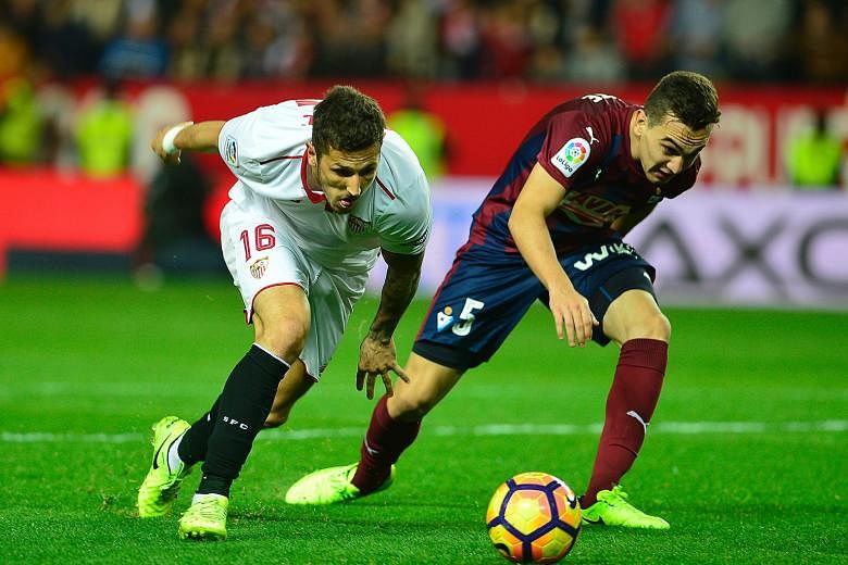 Sevilla's Stevan Jovetic (left) holds off Eibar's Gonzalo Escalante during their La Liga match on Saturday. The Montenegrin scored twice in his first two games for the Europa League winners, and his form will be a factor for Leicester City to take in