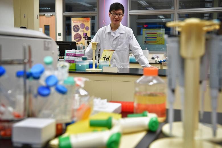 Mr Ee, seen here in a Nanyang Polytechnic lab, says his experience at GlaxoSmithKline Biologicals helped him better appreciate his course of study in Biologics and Process Technology.