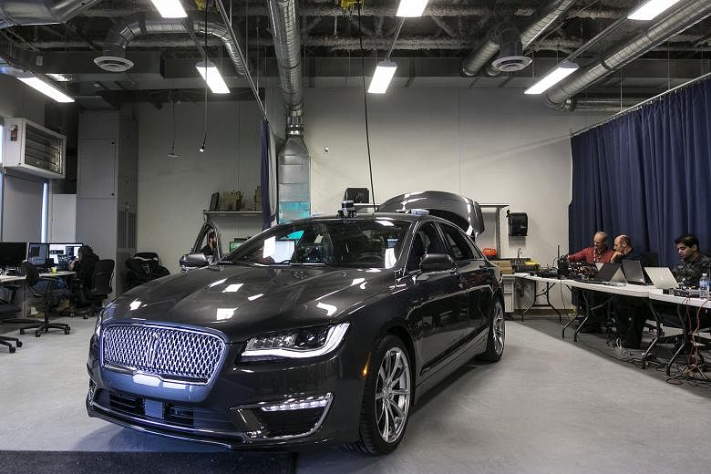A self-driving Ford Lincoln sedan. Ford will remove the steering wheel, brake and gas pedals from its driverless cars.