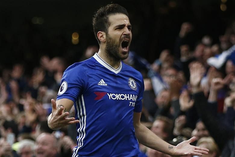 Chelsea's Cesc Fabregas celebrating after scoring his team's opening goal in the 3-1 Premier League win over Swansea at Stamford Bridge yesterday. Fernando Llorente equalised for the visitors before Pedro Rodriguez and Diego Costa sealed the win for 