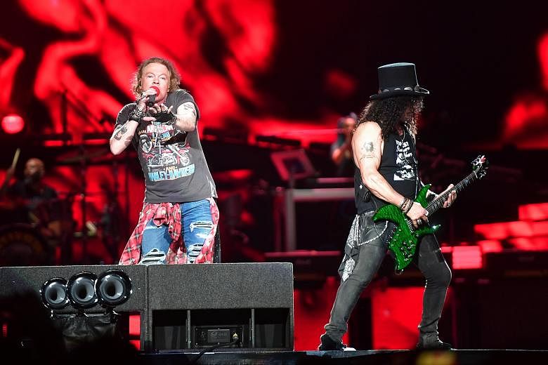 Guns N' Roses' frontman Axl Rose and guitarist Slash (both above) heating up the stage.