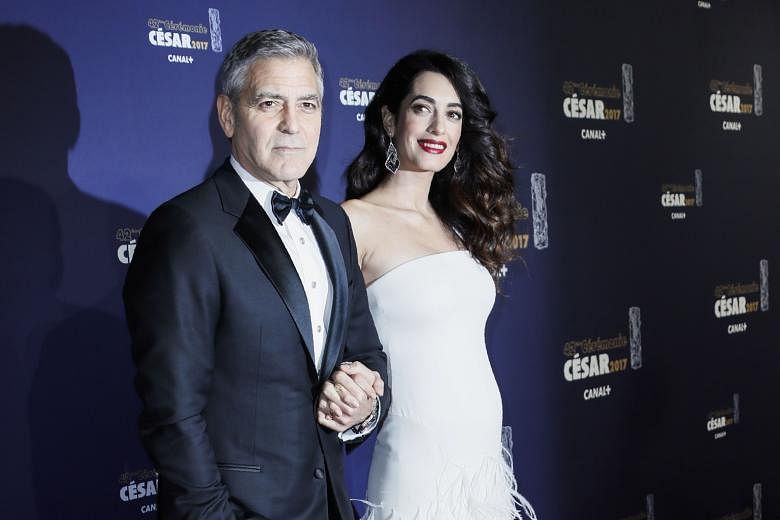 Hollywood actor George Clooney and his wife Amal, who is expecting twins in June, at the Cesars in Paris last week.
