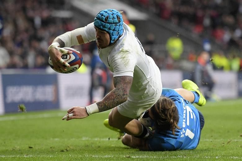 Substitute winger Jack Nowell evading the tackle of centre Michele Campagnaro to score the first of his two tries and England's fourth, in the 36-15 win over Italy at Twickenham.