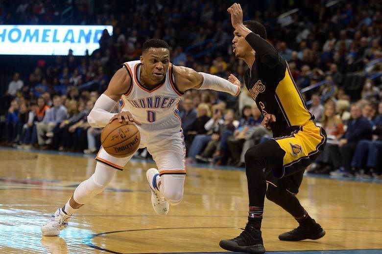 Oklahoma City guard Russell Westbrook driving past the LA Lakers' Jordan Clarkson during the Thunder's win on Saturday. Westbrook repeated his triple-double act against New Orleans.