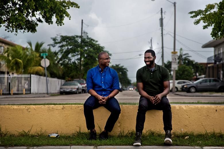 Moonlight director Barry Jenkins (far left) and writer Tarell Alvin McCraney in the Liberty Square housing project in Miami where they grew up.