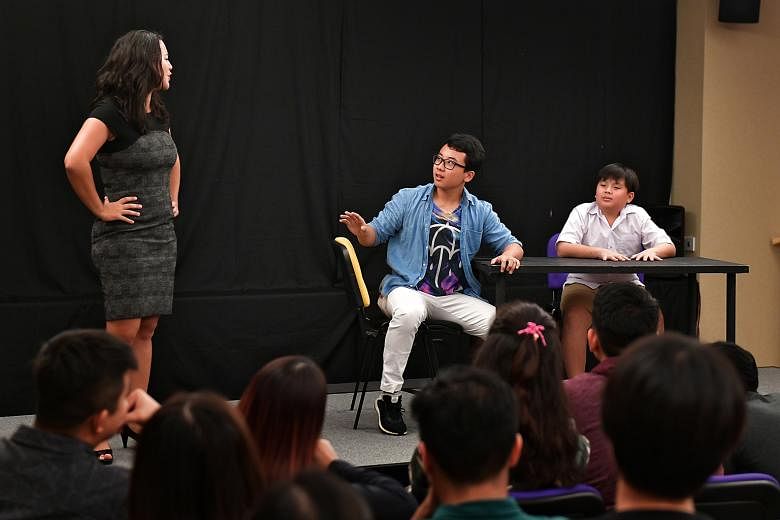 An audience member (in blue) jumping into the role of a father, in the play Don't Kancheong, Kiasu And Kiasi. The forum theatre piece was part of community group 100 Voices' campaign to collect feedback on how attitudes to education can be changed.
