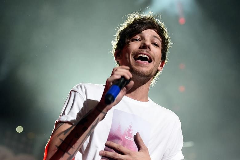 One Direction's Louis Tomlinson was arrested after an airport tussle with paparazzi.