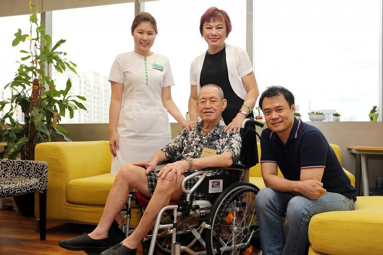 (From left) Patient navigator Miss Tan, Mrs Lee and her father-in-law Mr Lee, and Mr Andrew Soh from the Tsao Foundation's Hua Mei Centre for Successful Ageing. Mr Lee attends the centre every weekday, where he is placed under an eldercare programme.
