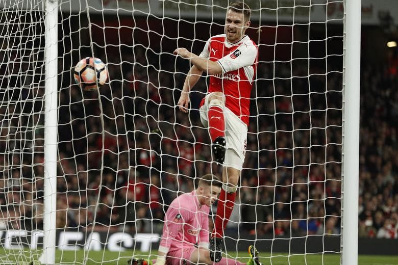 Midfielder Aaron Ramsey walking in Arsenal's fifth goal against non-league Lincoln City in the FA Cup quarter-finals.
