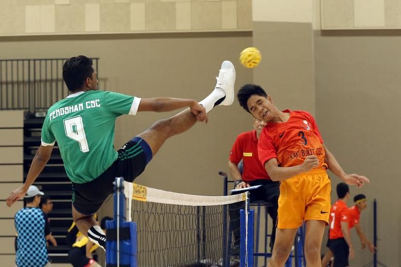 Noor Shafiq (right), from Kaki Bukit Community Sports Club, defending against his opponent from Fengshan Community Sports Club in a sepak takraw match on the first day of the Singapore Community Games.