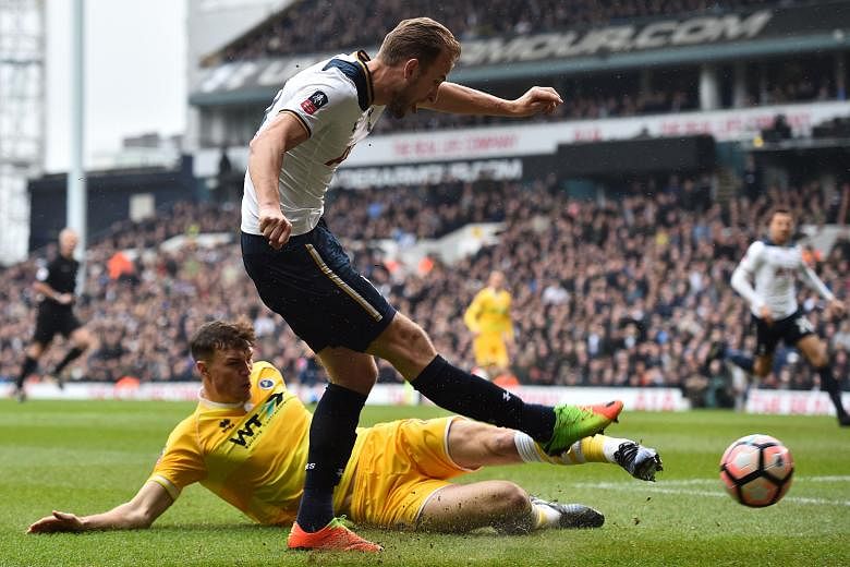 Tottenham striker Harry Kane is tackled by Millwall defender Jake Cooper as he shoots at goal during the FA Cup quarter-finals. Spurs won the match 6-0 but they lost Kane to an ankle injury.