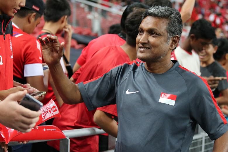 Coach V. Sundramoorthy thanking fans at last October's Causeway Challenge. He and FAS technical director Michel Sablon have had their contracts extended by two years.
