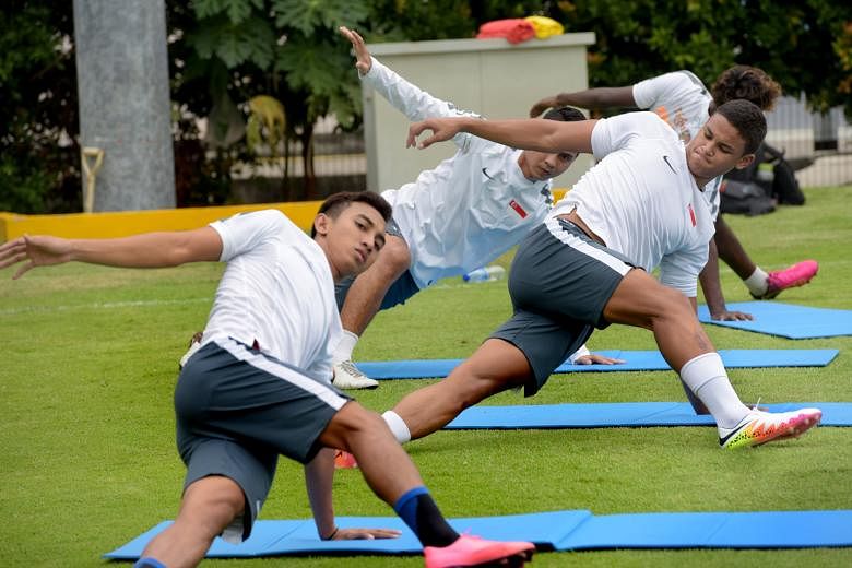 National footballer Irfan Fandi stretching during training last year. The enhanced Fifa warm-up programme presumably reduces injuries by improving muscle strength, balance and coordination, says associate professor Kristian Thorborg from the Universi