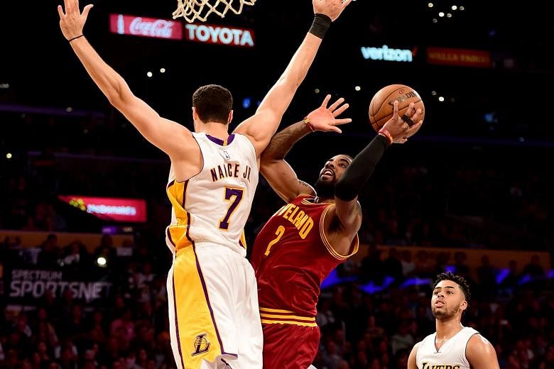 Cavs guard Kyrie Irving scoring on a lay-up past Lakers forward Larry Nance Jr in a 125-120 win at the Staples Center after a fourth-quarter spurt. The Cavaliers go 46-23 with the win and extend their Eastern Conference lead over the Boston Celtics t