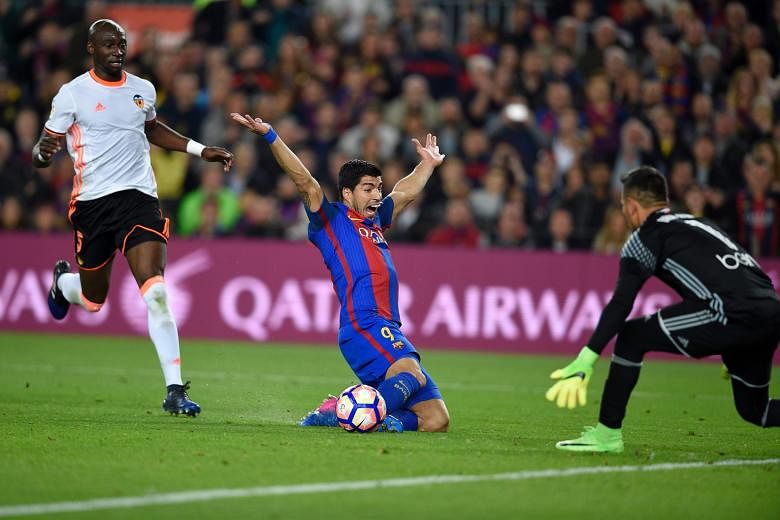 Barcelona's Uruguayan forward Luis Suarez appealing for a penalty when brought down by Valencia's Eliaquim Mangala at the Nou Camp Stadium. The French defender was sent off and Lionel Messi put the hosts 2-1 up from the spot. Barca won 4-2.