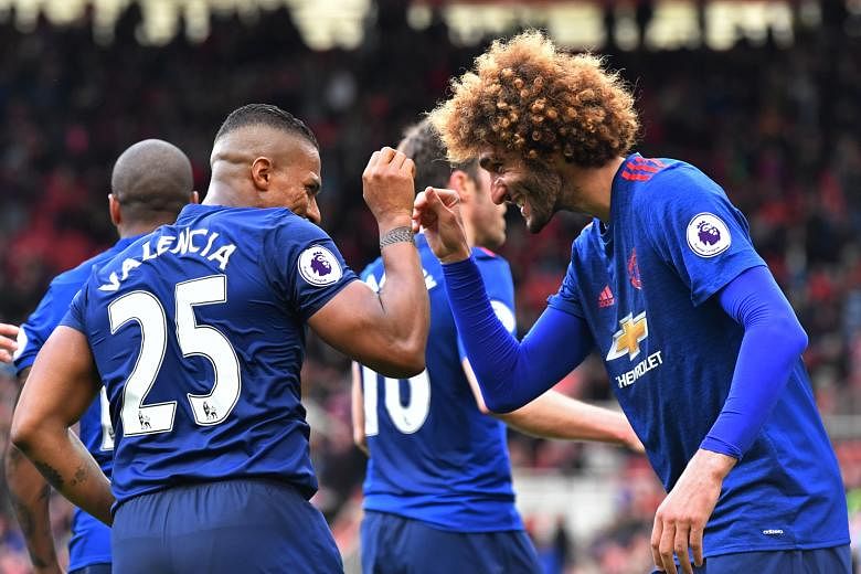 Manchester United right-back Antonio Valencia celebrating his 90th-minute goal with midfielder Marouane Fellaini. United will next play West Brom in the league as they continue their push on two fronts
