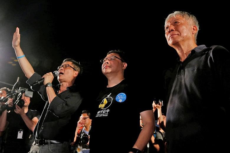 Occupy Central founders (from left) Chan Kin Man, Benny Tai and Chu Yiu Ming kicking off the movement in Hong Kong on Aug 31, 2014.