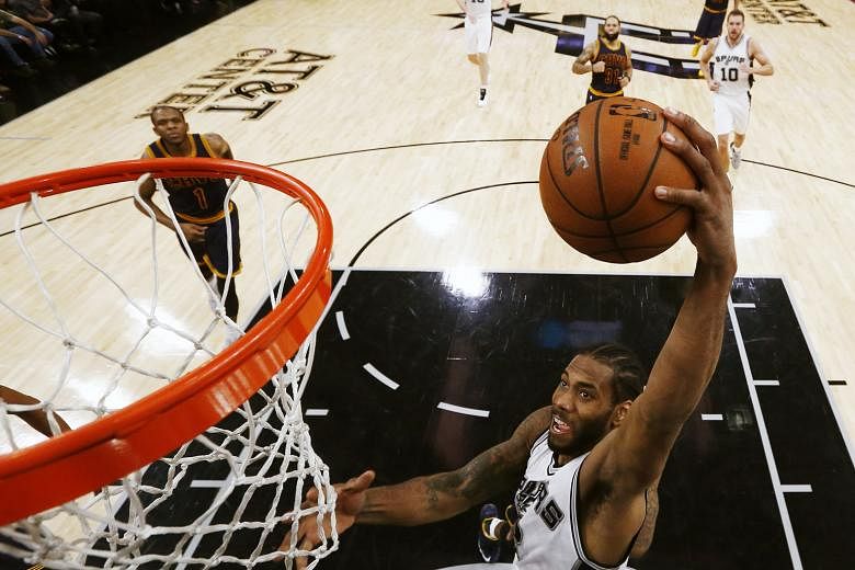 Spurs forward Kawhi Leonard going up for an easy basket in their 103-74 drubbing of the Cavaliers at the AT&T Centre in San Antonio, Texas. He top-scored with 25 points and left to a standing ovation as his team enjoyed their fifth straight win.