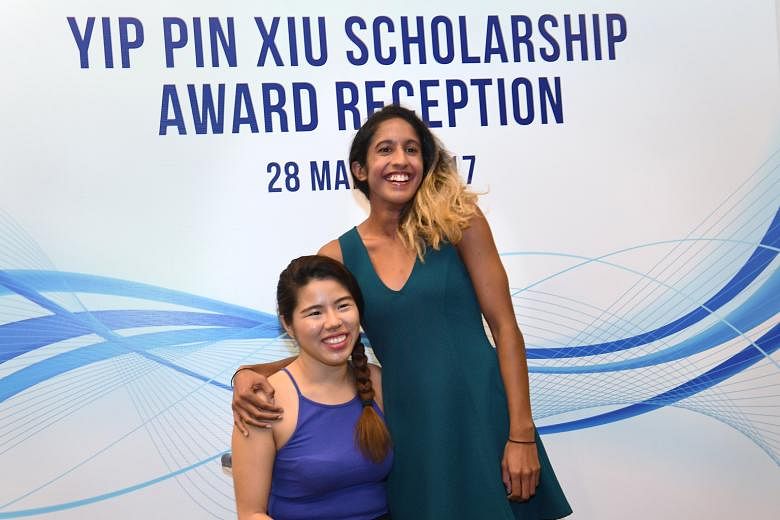 National sprinter Shanti Pereira poses with Yip Pin Xiu at a reception yesterday, when she was awarded a Singapore Management University scholarship that bears the three-time Paralympic champion's name.