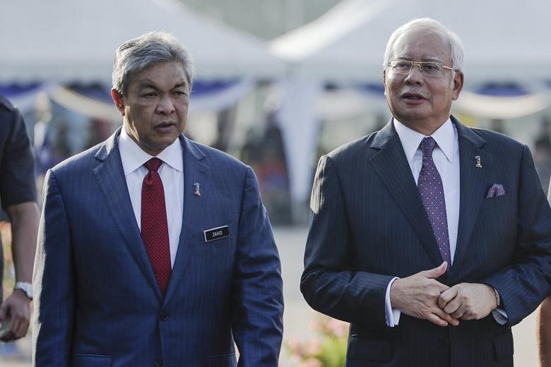 Mr Najib Razak and his deputy Zahid Hamidi (far left) at the 210th Police Day celebrations in Kuala Lumpur last Saturday. Netizens have pointed out a possible tension between the two leaders, given their conflicting statements over suggested amendmen
