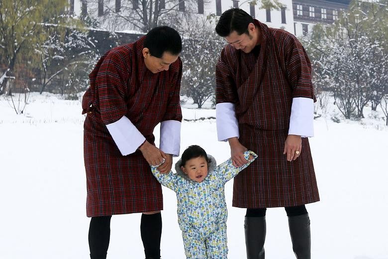 The King of Bhutan Jigme Khesar Namgyel Wangchuck (right) and his father, the fourth King of Bhutan Jigme Singye Wangchuck, supporting Bhutan's young prince Gyalsey Jigme Namgyel in Thimphu on March 11. Prince Jigme, who celebrated his first birthday