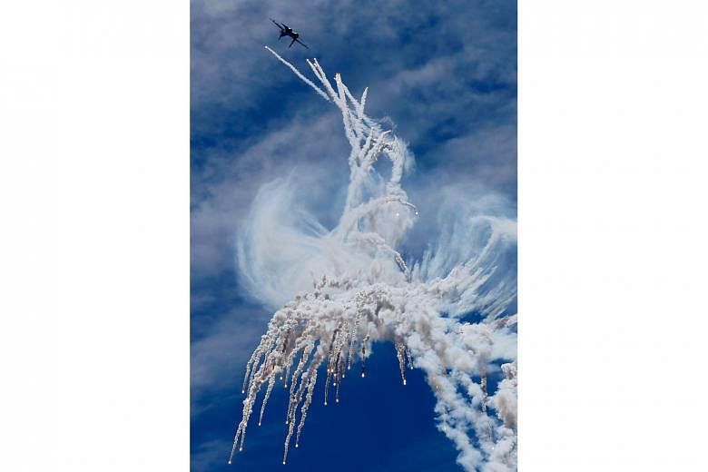 An Indonesian Sukhoi Su-30 jet fighter performing a stunt at a ceremony to mark the 71st anniversary of the Indonesian Air Force yesterday. Held at Halim Perdanakusuma Airport in Jakarta, the celebrations included performances or appearances by other