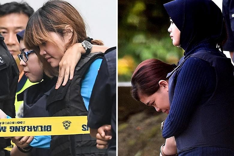 Vietnamese national Doan Thi Huong (left) and Indonesian national Siti Aisyah (right) being escorted by Malaysian police after a court appearance in Sepang yesterday. Lawyers for the two have complained that they had scant access to their clients.