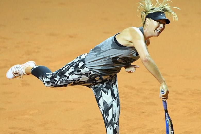 Maria Sharapova serving during a training session on the clay courts of Stuttgart ahead of her controversial return to competitive tennis after a doping ban. The Russian has met with disapproval for being allowed to make her anticipated return here.