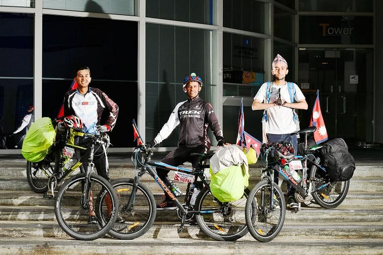 (From left) Mr Dilip Chhetri, Mr Nirmal Baral and Mr Anish Dhakal are cycling around the world to promote peace and spread awareness of environmental issues. Singapore is their 11th country since they left Nepal last December. So far, they have trave