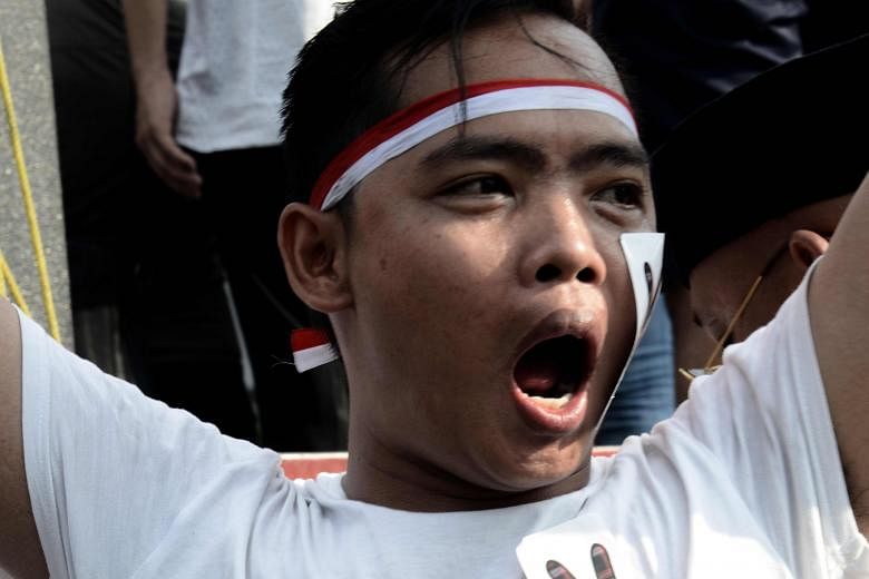 A protester demanding the release of the outgoing Jakarta governor Ahok outside the Indonesian High Court building last Friday. Various international groups have expressed concerns over the guilty verdict.