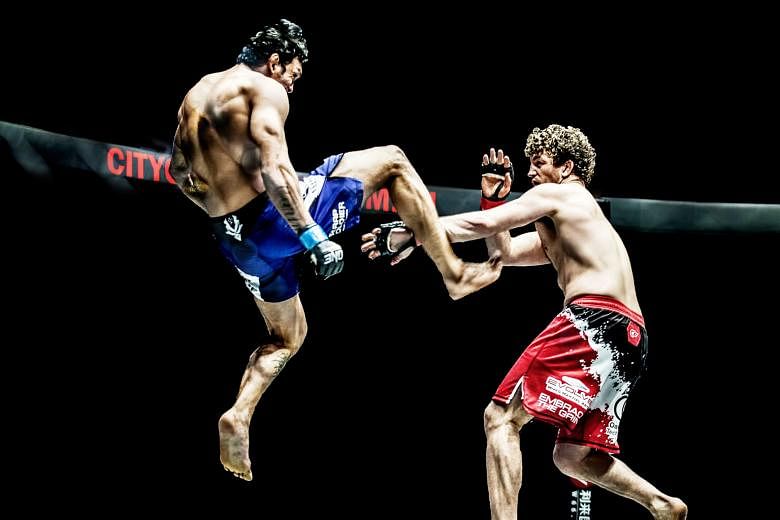 Ben Askren fending off a kick from Brazil's Luis Santos at their One Championship bout two years ago. The American - a former Olympic wrestler - will take on Malaysian Agilan Thani next Friday at the Singapore Indoor Stadium.