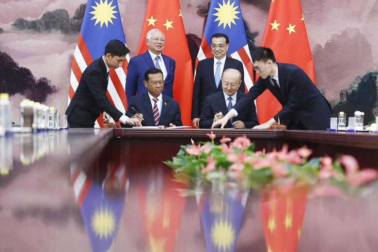 Malaysia's Prime Minister Najib Razak and Chinese Premier Li Keqiang observing a signing ceremony in Beijing last Saturday. The two countries are forging deep links.
