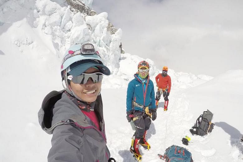 Trainee teacher Nur Yusrina Ya'akob gave Singapore a belated 50th birthday present on Monday morning when she reached the summit of the 8,848m-tall Mount Everest. 	A 2015 earthquake in Nepal had forced her to abort her climb after passing the 5,500m 