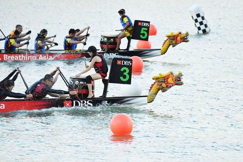 The DBS Asia Dragons (2min 36.742sec), in the No. 3 boat, edging out Hong Kong Disneyland Team Mushu Gold (2:36:768) to win the DBS Marina Regatta corporate mixed 12-crew 500m final at Marina Bay's The Promontory yesterday. The other winners were Sin