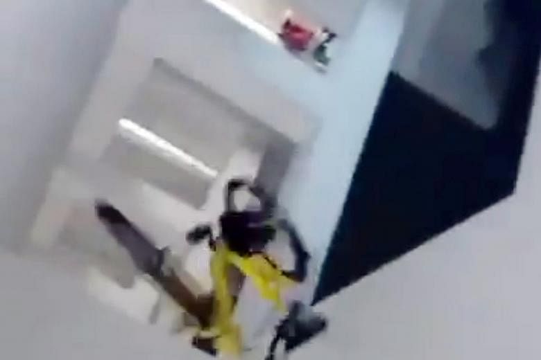 Stills from a video that has gone viral show a young man throwing an ofo bike from a Housing Board block in Whampoa yesterday. The bicycle got stuck on a lower-floor ledge of Block 116B, Jalan Tenteram.