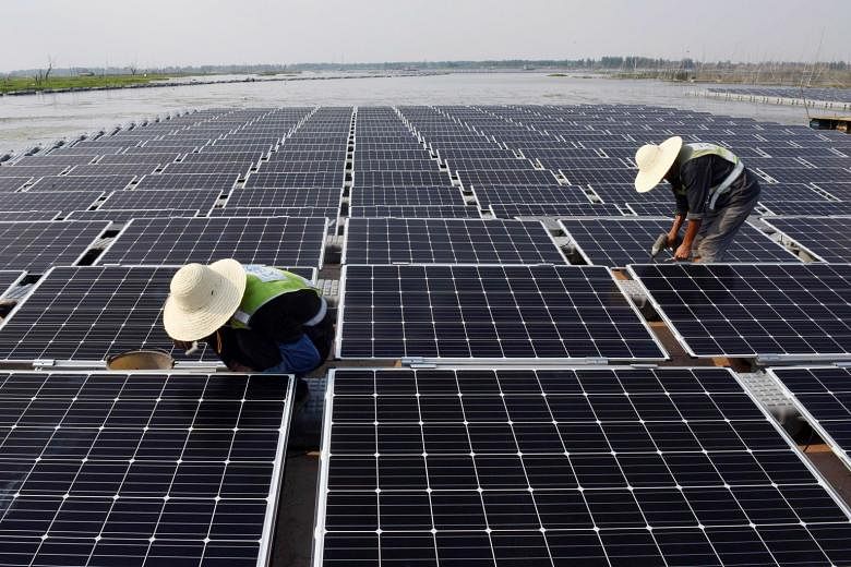 Workers at the world's largest floating solar power plant in a lake in Huainan, in China's central Anhui province. The solar farm can generate 40MW of electricity. With the One Belt, One Road project, China's President Xi Jinping and his economic pla