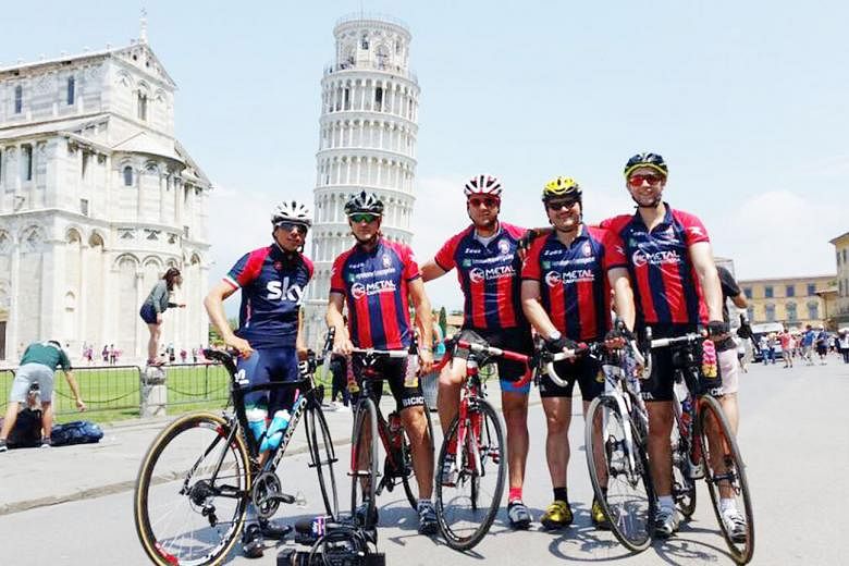 Crotone manager Davide Nicola (second from left) and his cycling companions in front of the Leaning Tower of Pisa, during the 1,300km journey to Turin.