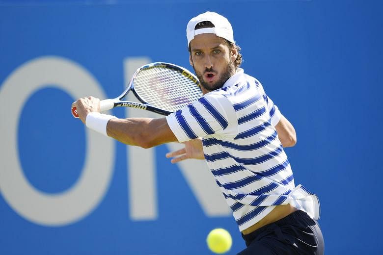 Spain's Feliciano Lopez returning against Stan Wawrinka of Switzerland in their first-round match at the Queen's Club. The world No. 3's Wimbledon preparations suffered a blow after being dumped out, with world No. 6 Milos Raonic joining him