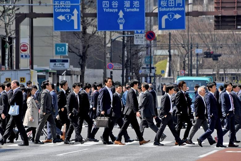 Japanese salarymen on the move in Tokyo. According to a survey, the percentage of children who said they respected their mothers surged to a record high of 68.1 per cent, surpassing for the first time the proportion - 62 per cent - who said they resp