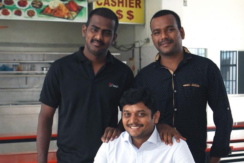 Mr Veluchamy Muniapparaj, an operations executive at a workers' dormitory, flanked by Mr Munusamy Sugumar (far left) and Mr Vadivel Sakthivel, whom he had advised on how to recover their unpaid wages.