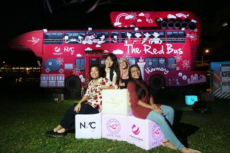 Nanyang Academy of Fine Arts (Nafa) students - (from left) Liza Markus, 22; Siow Ziyi, 23; Nur Fadlin Fazirah, 22; and Nur Yuhanis Yusof, 24 - in front of a mural they painted together with two other students. The mural, on a bus in front of Red Box 