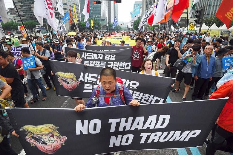 Protesters marching in Seoul last month against the deployment of the US Thaad anti-missile system, ahead of a summit between US President Donald Trump and South Korean leader Moon Jae In.