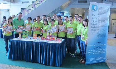 Staff from food and health supplements company Cerebos Pacific man the booths selling Brand's products at the atrium of China Square Central on Wednesday, Sept 11, 2013. -- PHOTO: CEREBOS