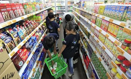 Beneficiaries of The Straits Times School Pocket Money Fund shopping at a Cheers convenience store outlet in Downtown East on Aug 31, 2013. The Straits Times School Pocket Money Fund (SPMF) will increase the monthly amount it gives to students from l