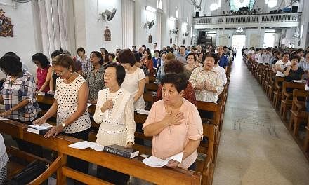 About 500 Singaporeans and Filipinos attended a solidarity mass led by Archbishop William Goh at the Church of Saints Peter and Paul on Tuesday evening.&nbsp;-- ST PHOTO:&nbsp;ASHLEIGH SIM