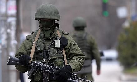 Russian soldiers patrol outside the navy headquarters in Simferopol on March 18, 2014. -- PHOTO: AFP